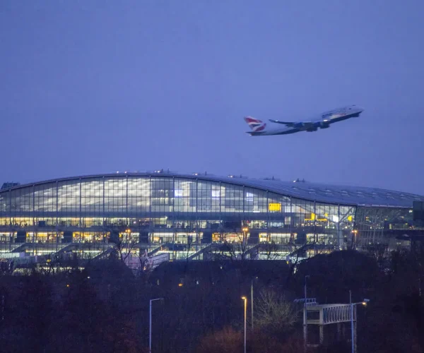 Jet-airplane-taking-off-Terminal-5-Heathrow-Airport-England-night